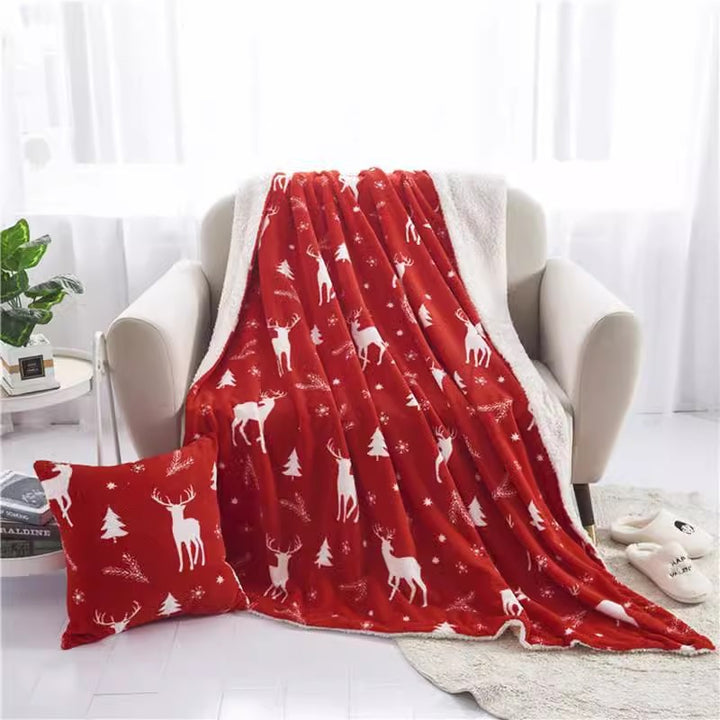 Christmas fleece throw blanket on a sofa