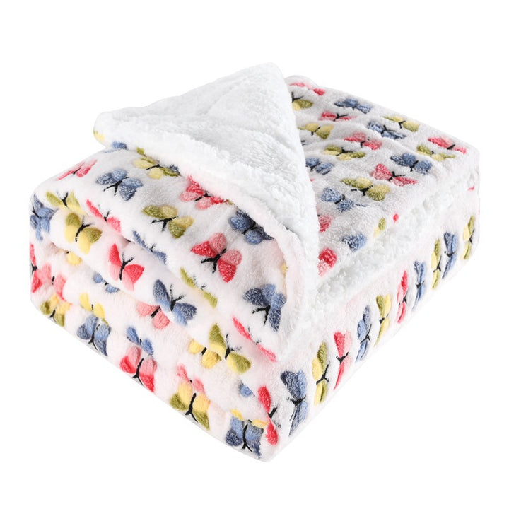 Thick sherpa blanket folded on a sofa