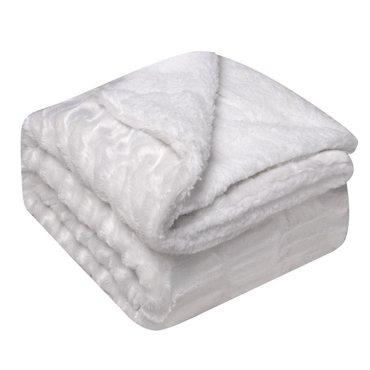 Thick sherpa blanket folded on a sofa