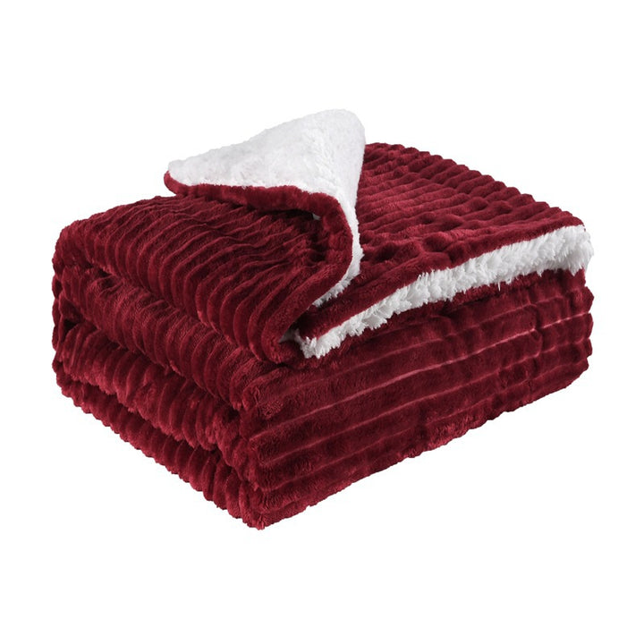 Thick sherpa blanket folded on a sofa